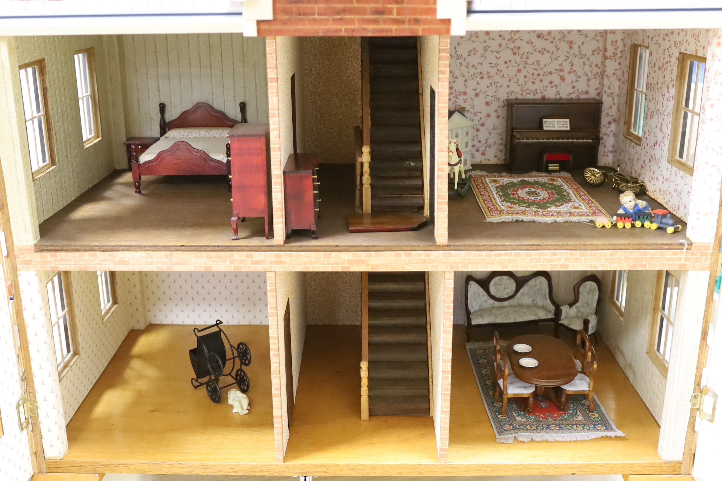 A mid 20th century doll's house and contents, 84cms x 100cms high
